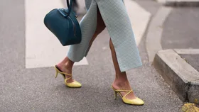 Woman at fashion week wears straight maxi skirt and yellow comfortable high heels