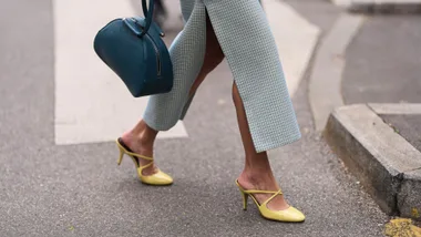 Woman at fashion week wears straight maxi skirt and yellow comfortable high heels