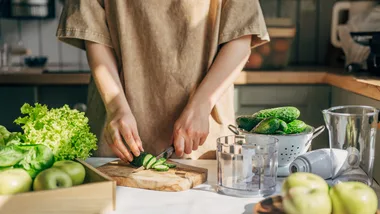 woman cutting cucumber