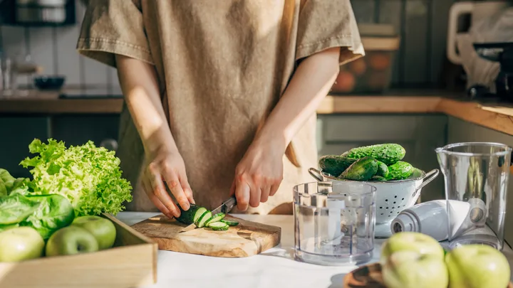 woman cutting cucumber