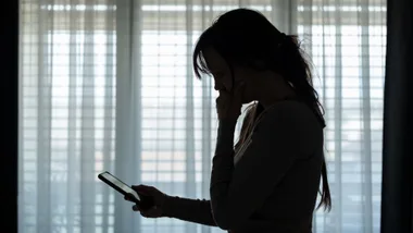 woman looking at phone in the dark