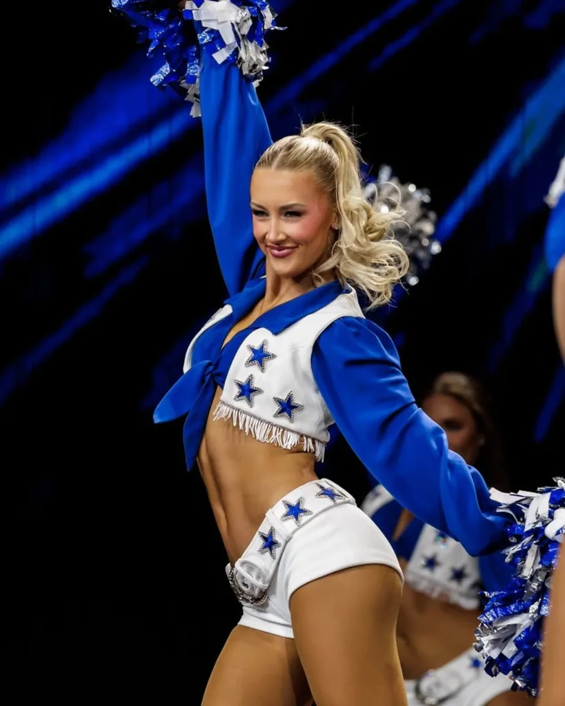 Dallas Cowboys Cheerleader Faith Ward dancing in the DCC blue-and-white uniform