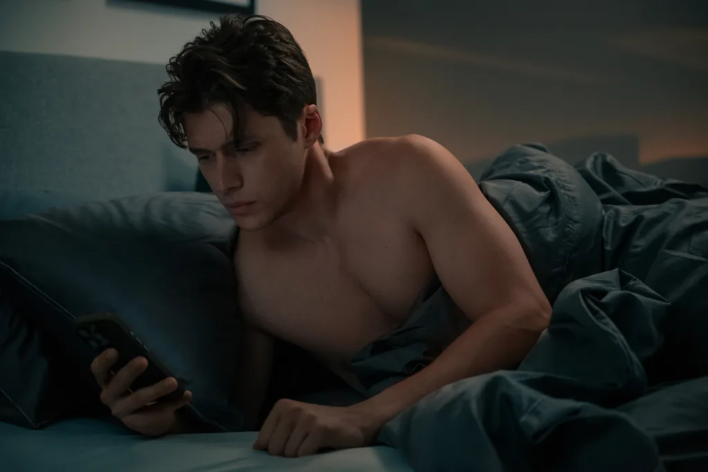 Nick Robinson in bed shirtless in Voicemails For Isabelle