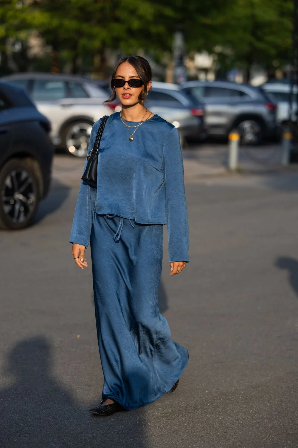 Woman street style wearing blue satin skirt and matching top