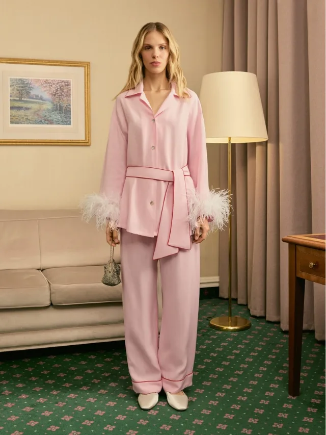 Woman in hotel room wears pink pyjama set with