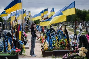 Ulyana near the grave of her husband in the section of a local cemetery dedicated to fallen soldiers in Kyiv, Ukraine. Photograph: Serhii Korovayny, 29 May 2026