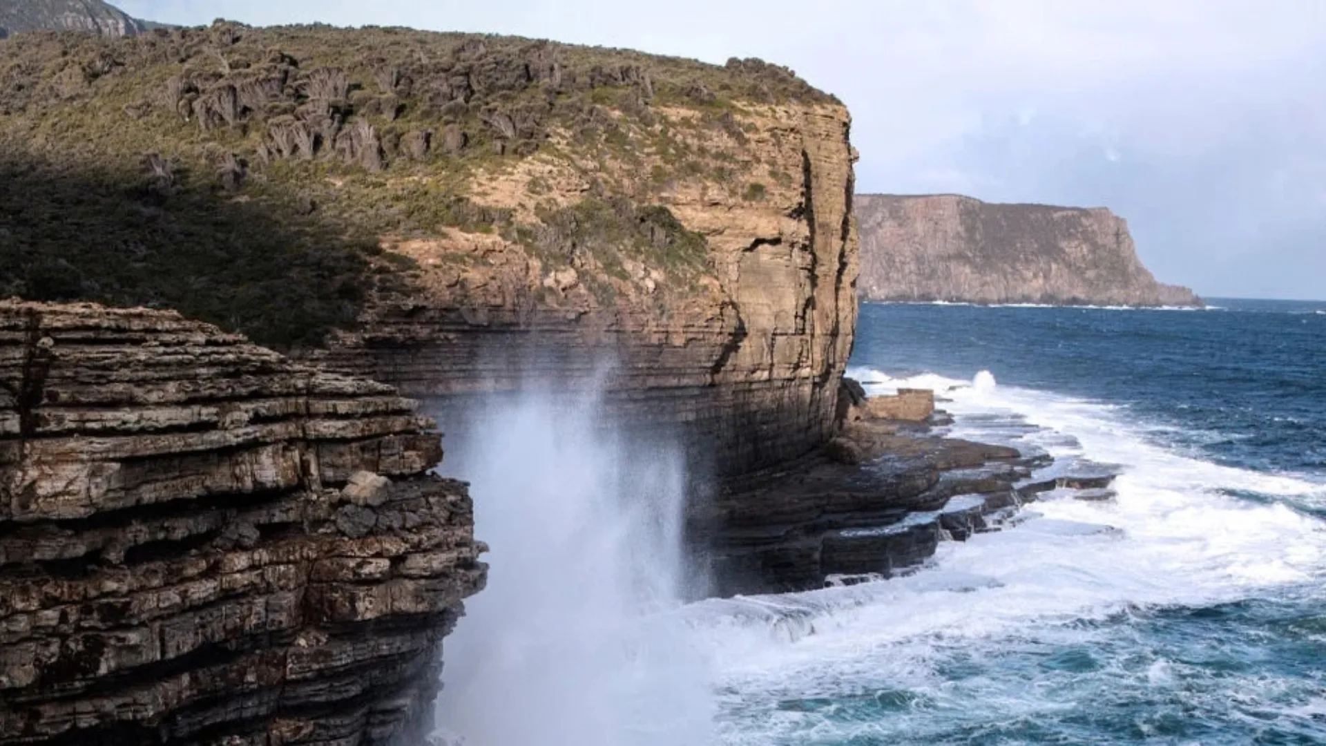 The ocean and large cliffs on Tasmania's coast.