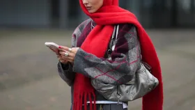 girl with red carf holding phone