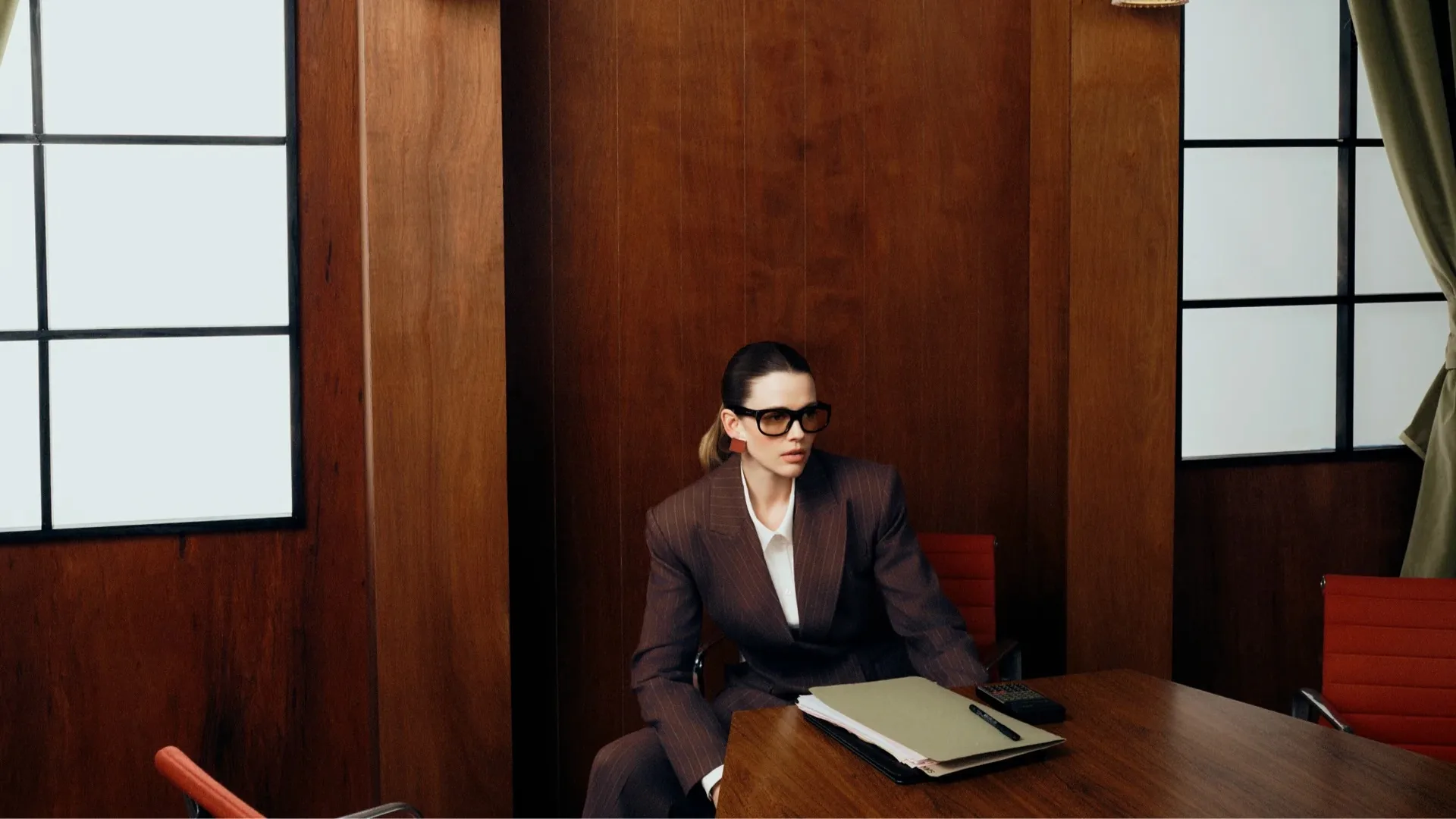 A model in a brown suit against a brown background