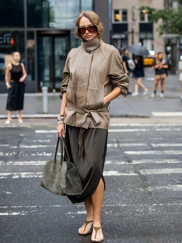 Woman at New York Fashion Week carries green suede bowling bag