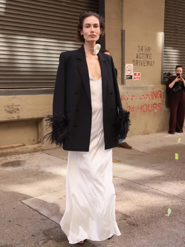 Woman wears white maxi dress with long black blazer in summer