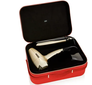 GHD The Deluxe Gift Set, $680, features the ghd Platinum+ Styler and ghd Helios Hair Dryer in limited edition champagne gold, enclosed in an exclusive red velvet vanity case.