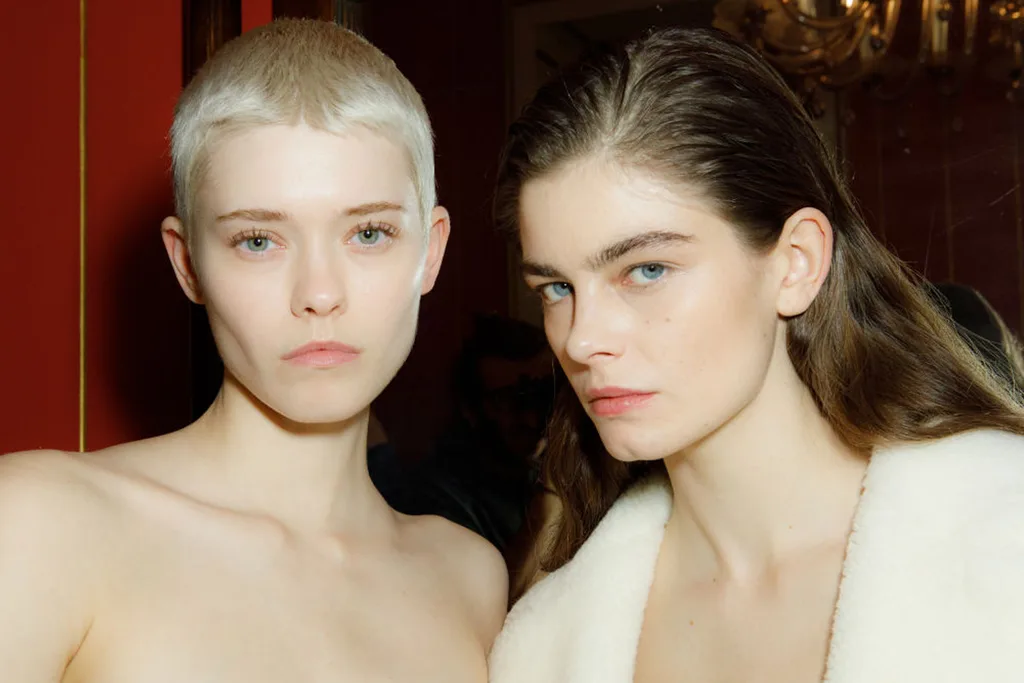 two catwalk models. short blonde pixie do. Sleek back long hair