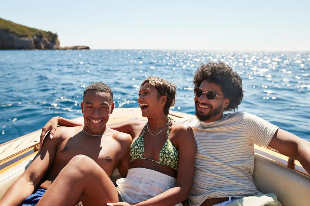 ethical-non-monogamy-three-people-smiling-in-a-boat-on-a-sunny-day