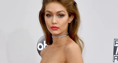 Gigi Hadid Steps On To The AMAs Red Carpet In White Lace