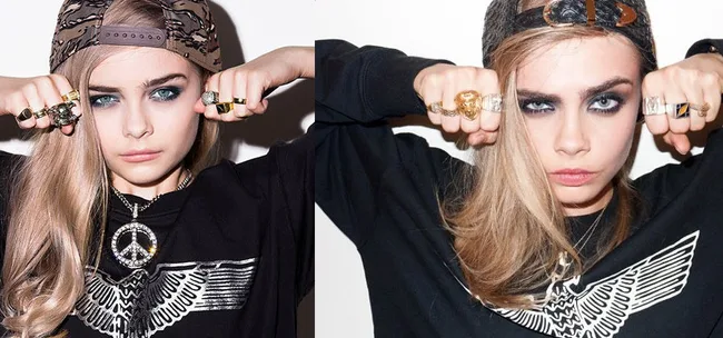 Young woman with long hair in a cap, striking fists forward, wearing a black graphic sweater and multiple rings.
