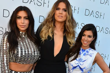 This Awkward Photo Of Kim and Kourtney Covering Khloe’s Baby Bump Will Make Your Day