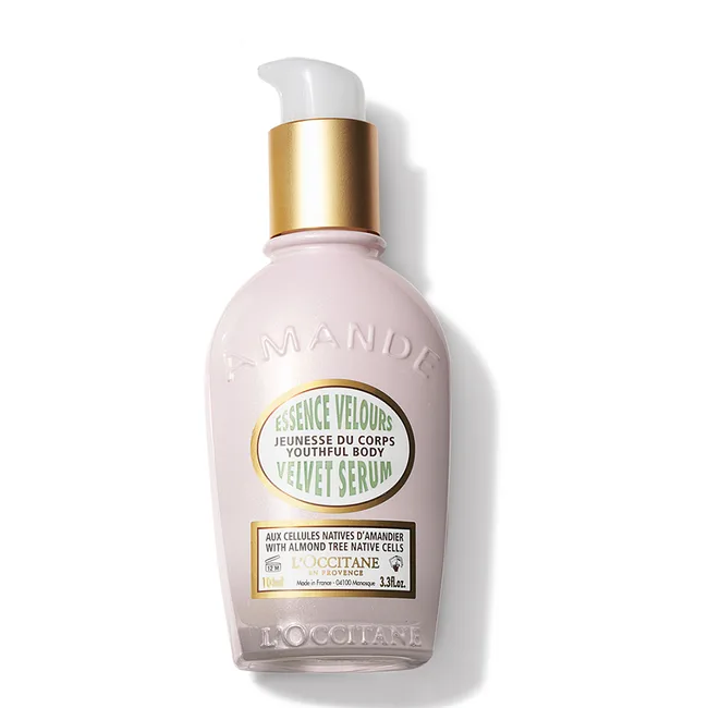 L'Occitane Amande Velvet Serum bottle with gold pump, labeled for youthful body care.