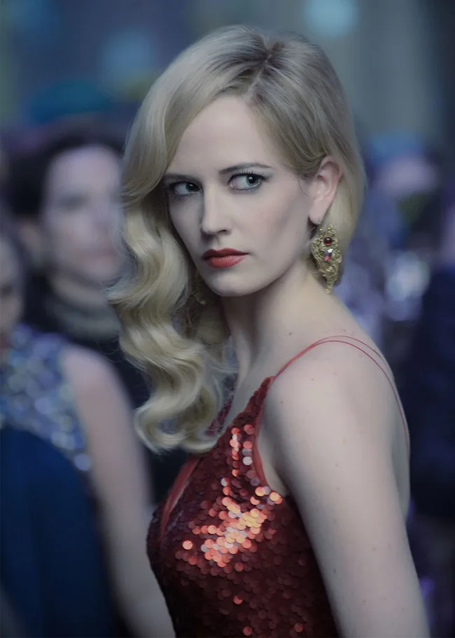 A woman with blonde hair in a red sequined dress looking sideways.