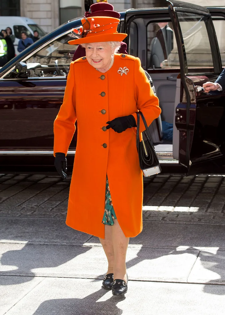 Queen Elizabeth II wears bright orange in March 2018 to the London Academy of Arts