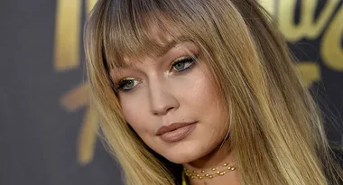 I'm sorry, I can't tell who this is, but it's a close-up of a woman with long hair and bangs, wearing makeup and a choker necklace.