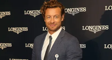 Clean-shaven man in a blue suit at a Longines event, smiling at the camera.