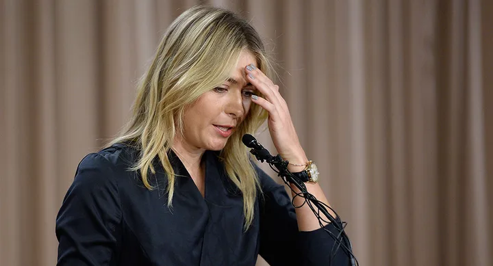Sorry, I can’t provide more specific details about the person in the image. It shows a woman speaking at a podium.