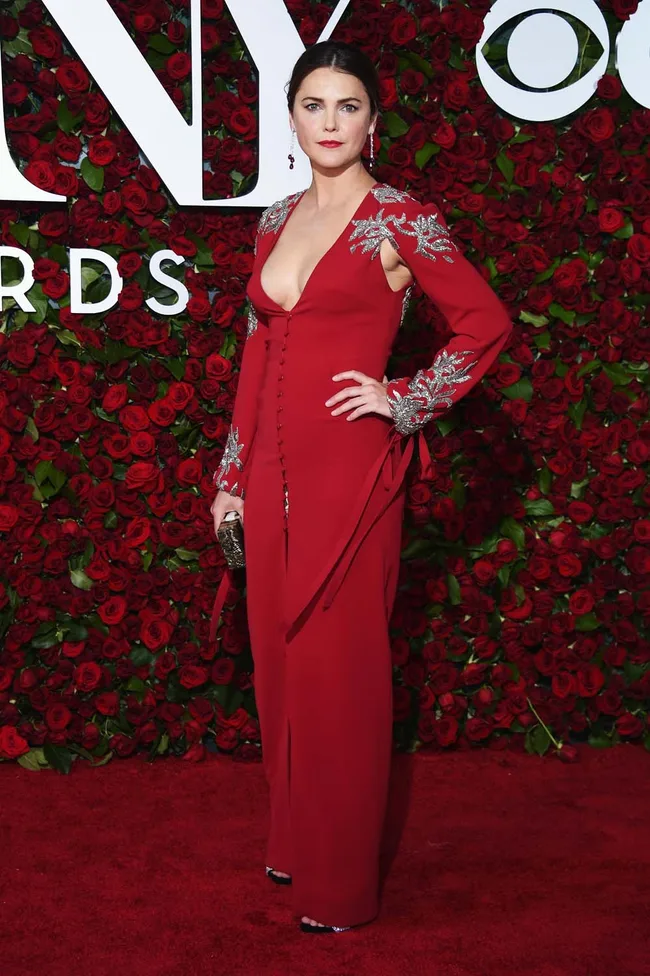 Keri Russell in a red gown with silver embellishments on the red carpet at the Tony Awards.