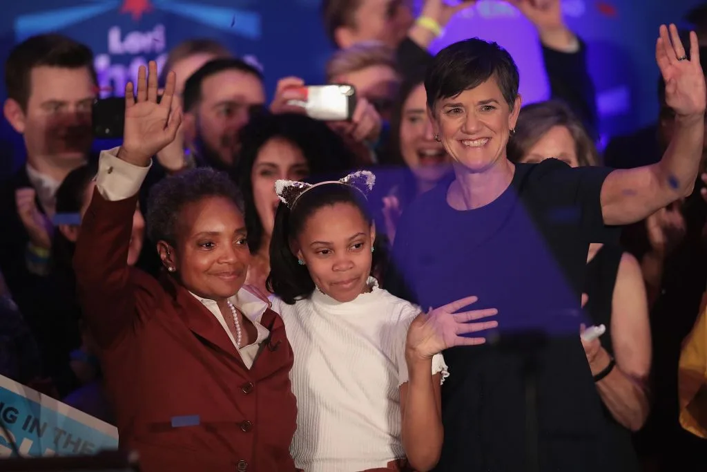 Lori Lightfoot (L) celebrates with her wife Amy and daughter Vivian