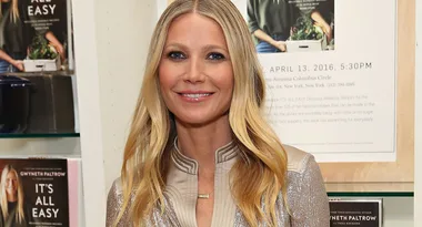 Woman with long blonde hair smiling in front of a book display titled "It's All Easy."