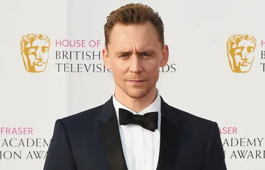 Man in a tuxedo at the British Academy Television Awards, standing in front of a branded background.