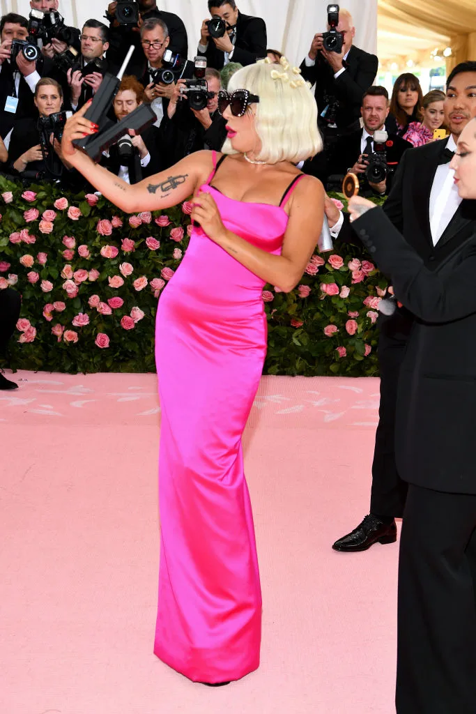 lady gaga's third look at the 2019 met gala was a form fitting neon pink dress with spaghetti straps
