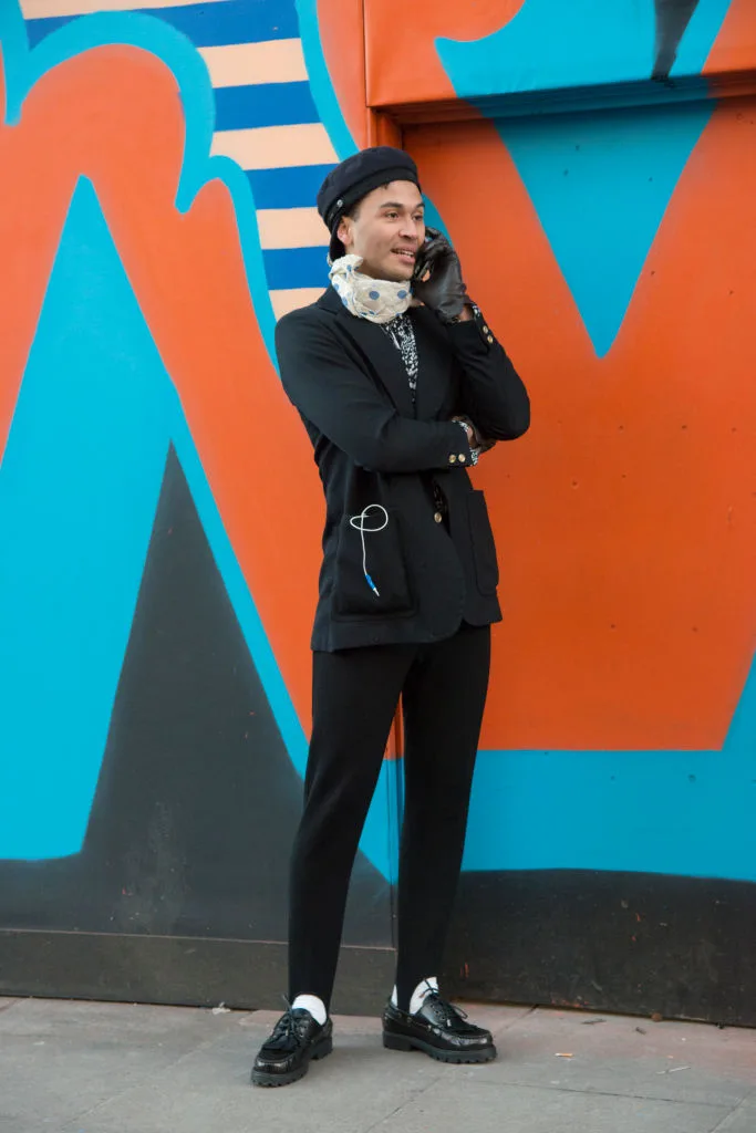 Guy wearing stirrup black pants and a jacket