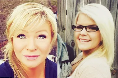 Two women with blonde hair smile, one wears glasses, standing outdoors with a wooden fence background.