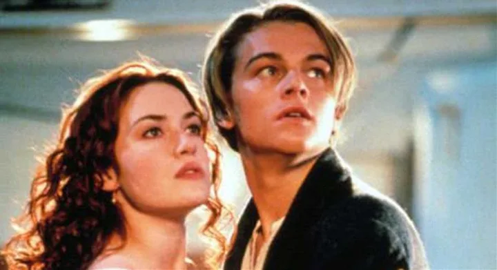 A young man and woman gaze upward in a dramatic scene from the movie "Titanic."