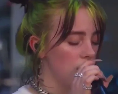 Billie Eilish laughs on stage when a fan yells out to her