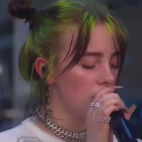 Billie Eilish laughs on stage when a fan yells out to her