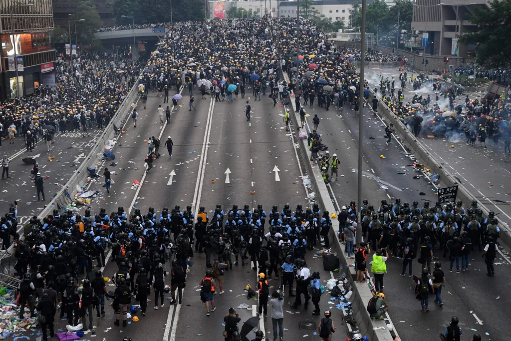 Protesters face off with police after they fired tear gas during a rally against a controversial extradition law proposal outside the government headquarters in Hong Kong on June 12, 2019