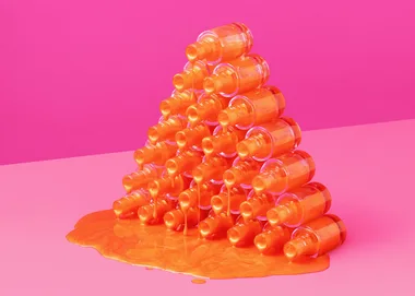 Orange nail polish bottles stacked in a pyramid with polish spilling onto a pink background.