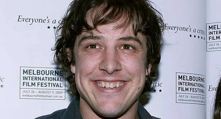 Smiling person at Melbourne International Film Festival backdrop, July-August 2009.