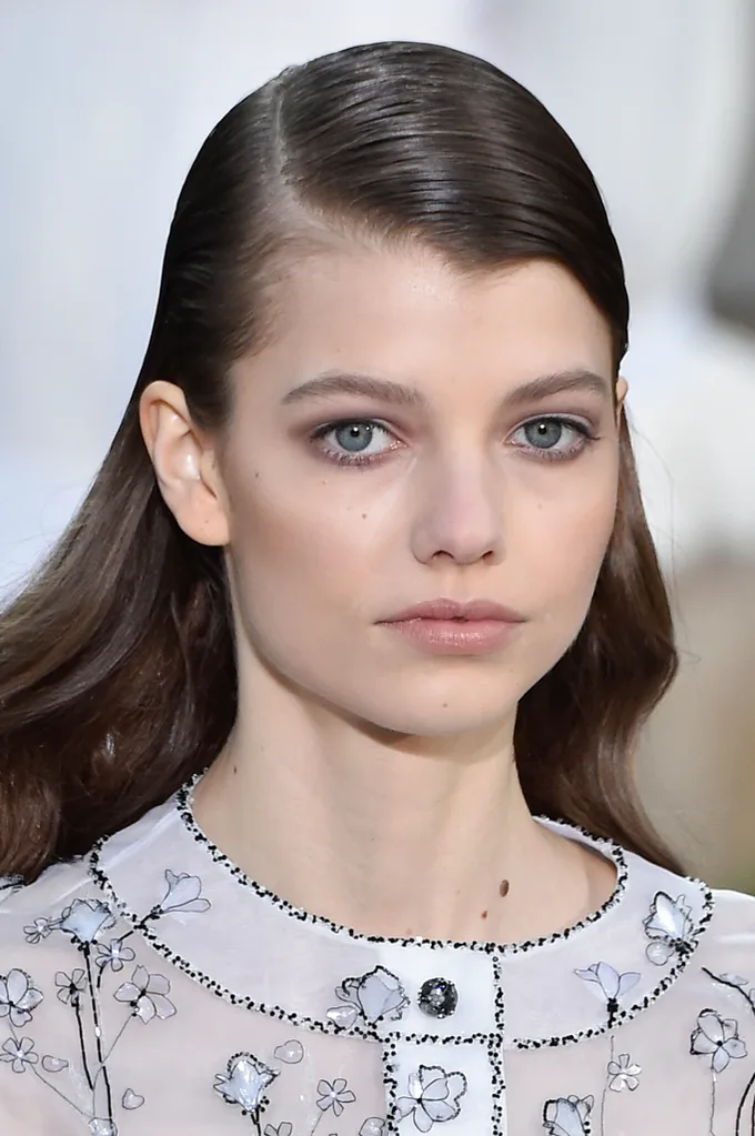 Models wore combed-over hair with deep side parts at CHANEL.