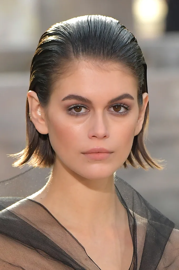 Models wore combed-over hair with deep side parts at CHANEL.