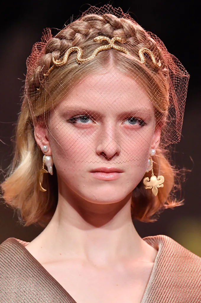 Braids adorned with gold snake headbands at Dior.