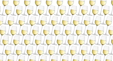 Pattern of multiple white wine glasses arranged diagonally on a white background.