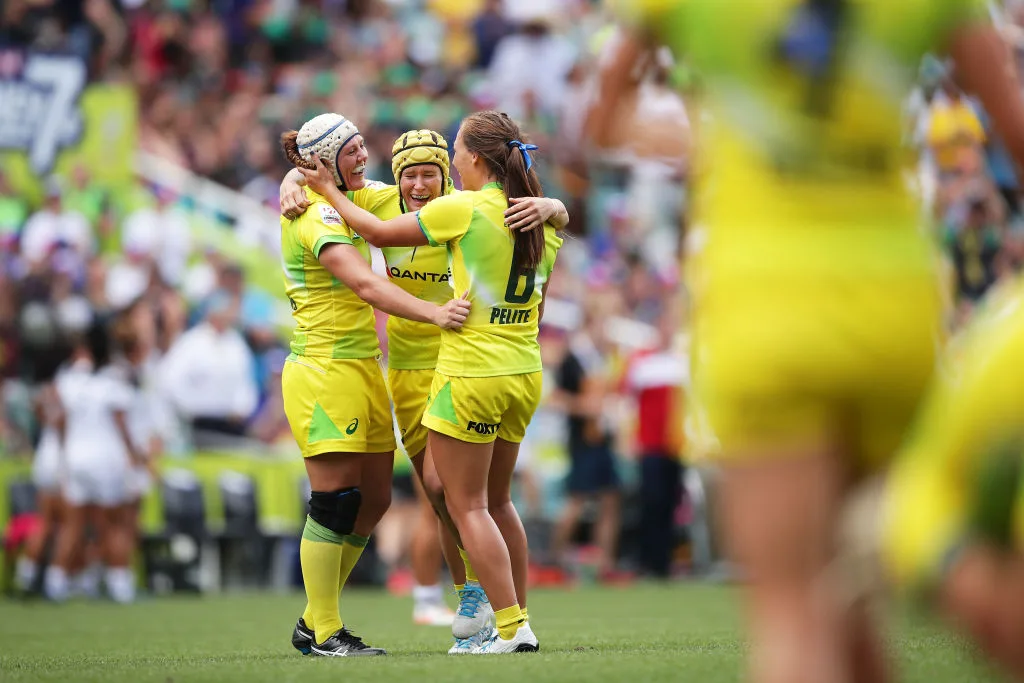 Sharni Williams, Shannon Parry and Evania Pelite of Australia celebrate victory at the end of final match against New Zealand during day three of the 2018 Sydney Sevens at Allianz Stadium