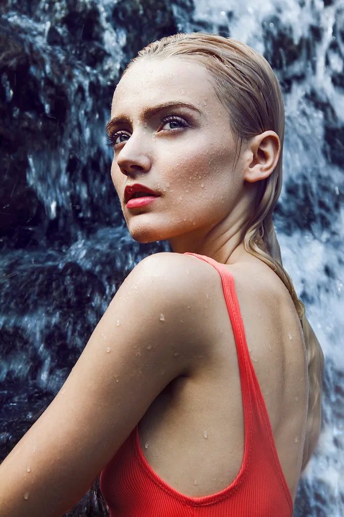 Woman in waterfall