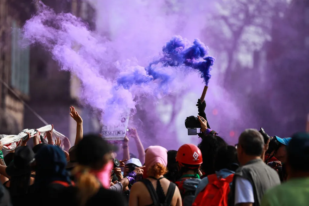 A smoke torch is seen during a protest on the International Women's Day in Mexico City,