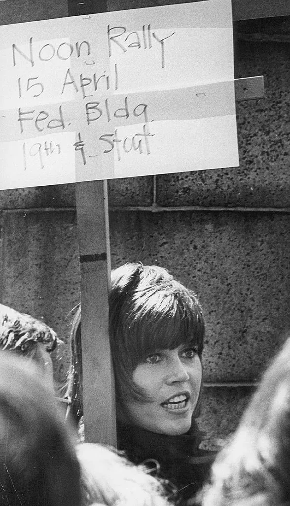 Jane Fonda displays protest sign during fast for peace