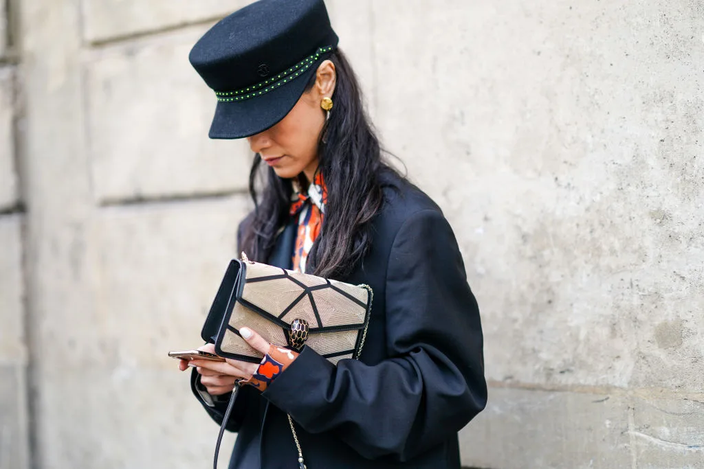 A woman looking down at her phone