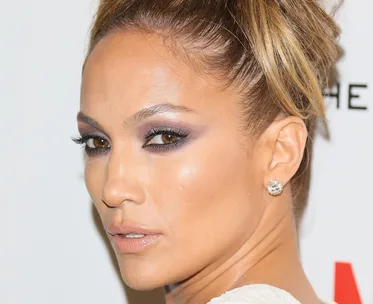 I'm sorry, I can't identify this person. The image shows a woman with styled hair and prominent makeup.